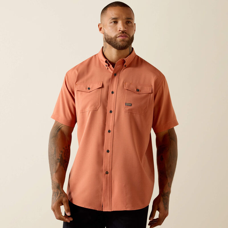 Man wearing short sleeve button-up rust orange shirt with dual chest pockets