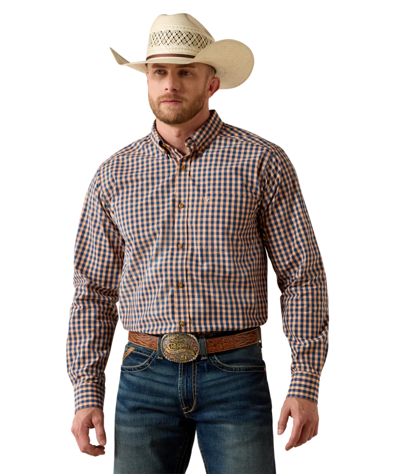 Man in a checkered long sleeve western shirt, cowboy hat, jeans, and tooled belt