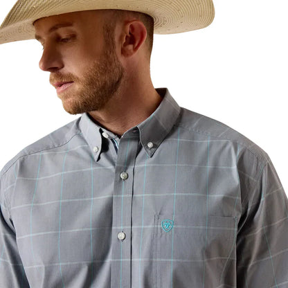 Man wearing a gray plaid shirt with a brand logo and a straw hat on a white background