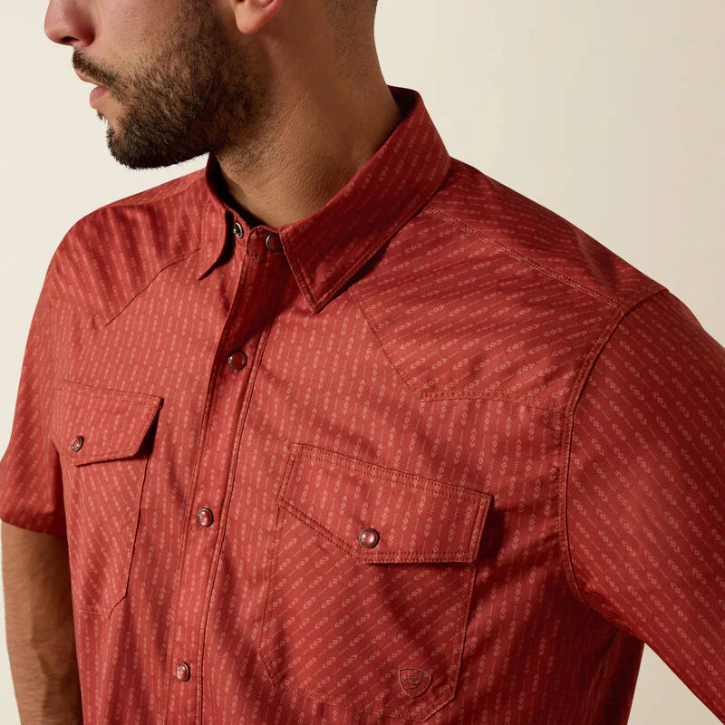 Red patterned shirt worn by a person on a white background