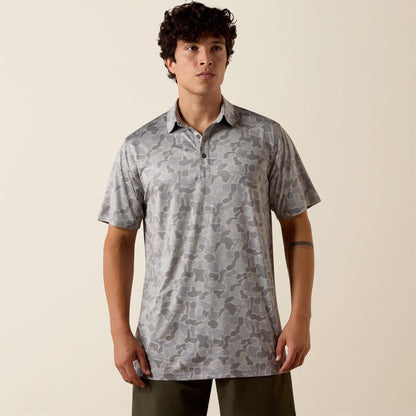 Man wearing a patterned shirt against a beige background
