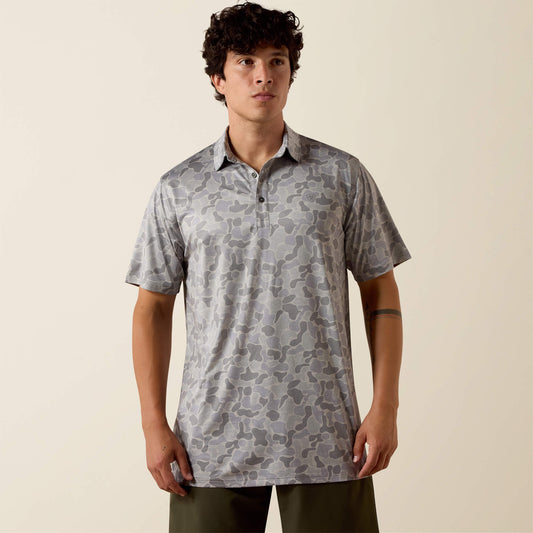 Man wearing a patterned shirt against a beige background