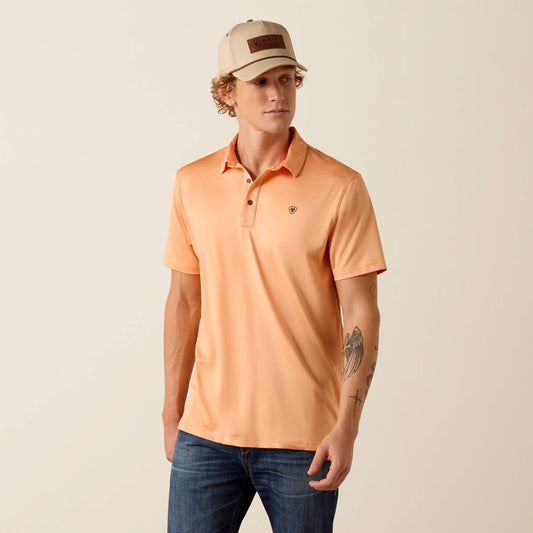Man wearing an orange polo shirt and beige cap on a beige background
