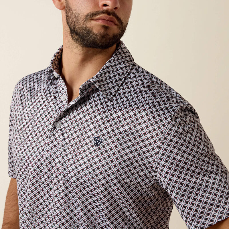 Man wearing a patterned shirt against a beige background