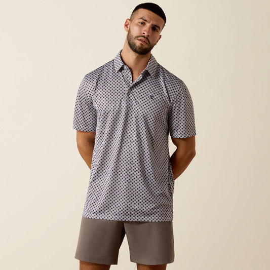 Man wearing a patterned polo shirt and shorts on a beige background