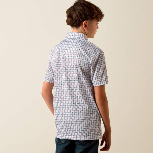Person wearing a patterned short-sleeve shirt against a plain background