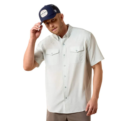 Man wearing a light-colored button-up shirt and navy cap with 'Array' branding on a white background