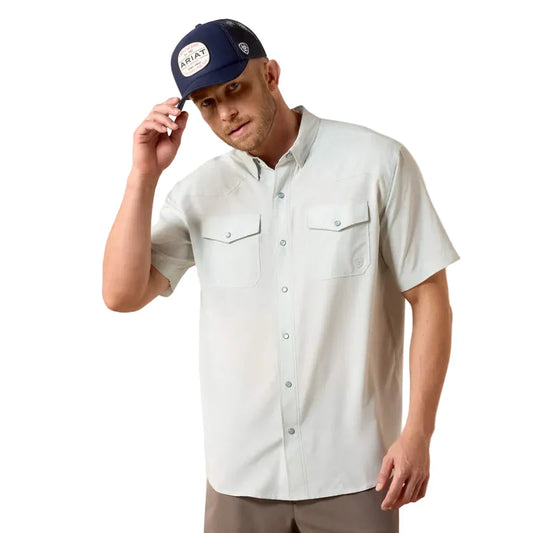 Man wearing a light-colored button-up shirt and navy cap with 'Array' branding on a white background
