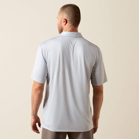 Man wearing a gray polo shirt against a beige background