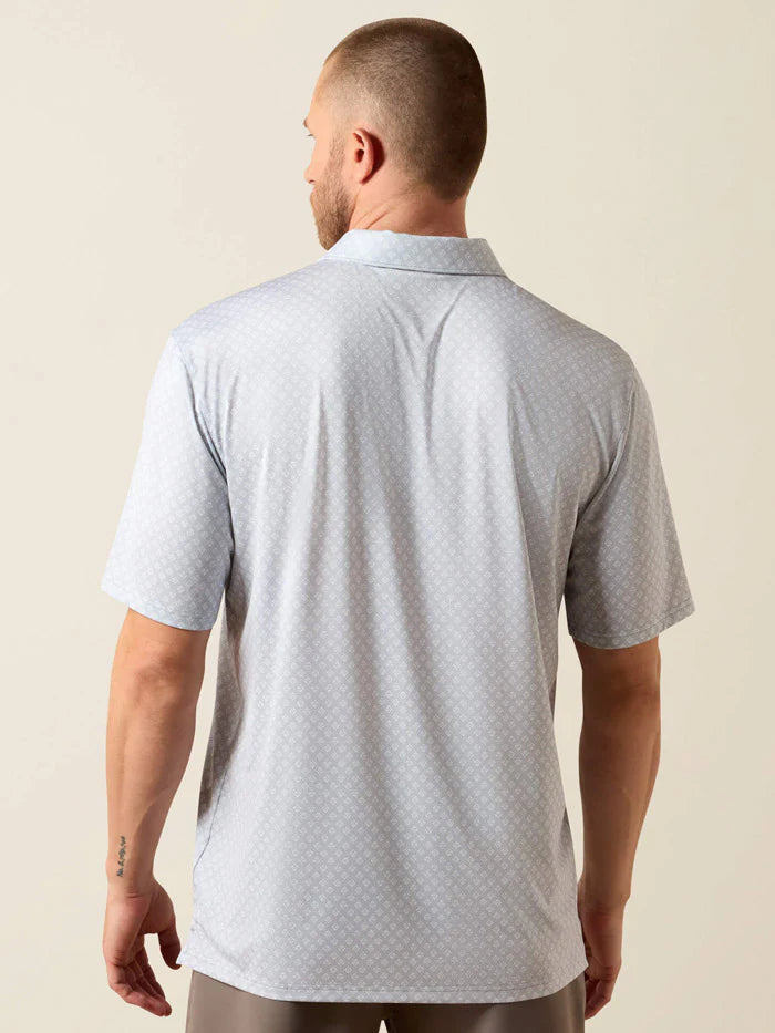 Man wearing a light gray polo shirt against a beige background