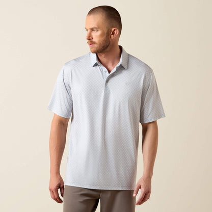 Man wearing a light gray patterned polo shirt against a beige background