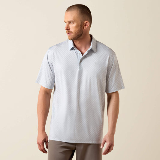 Man wearing a light gray patterned polo shirt against a beige background