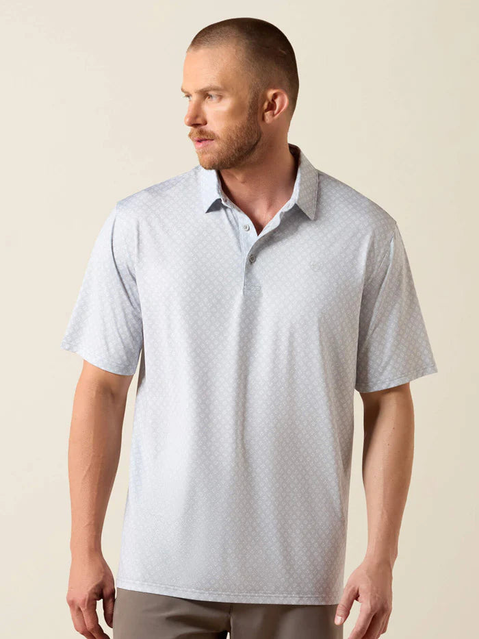 Man wearing a light gray polo shirt against a beige background