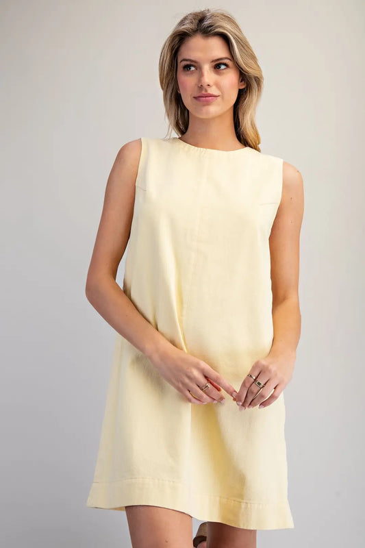 sleeveless shift dress features a simple round neckline and a minimalist A-line silhouette