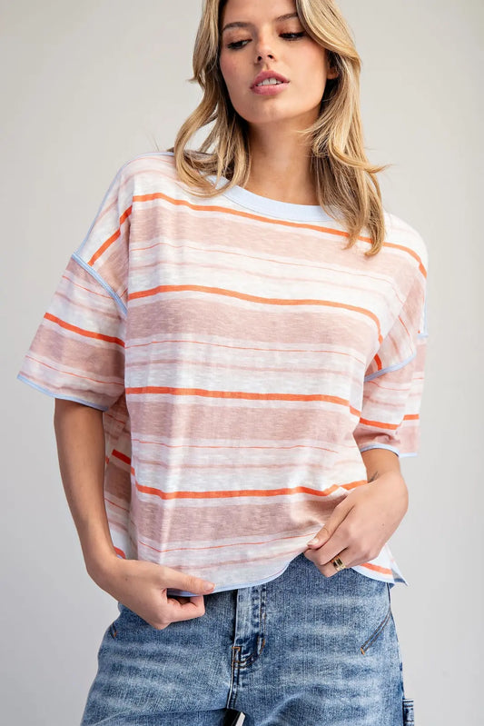 Woman wearing a striped shirt with a plain background
