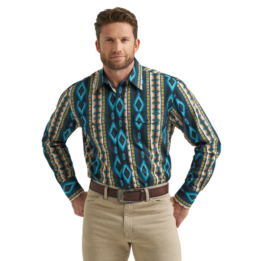 Man wearing long sleeve western shirt with blue geometric Aztec print and beige pants