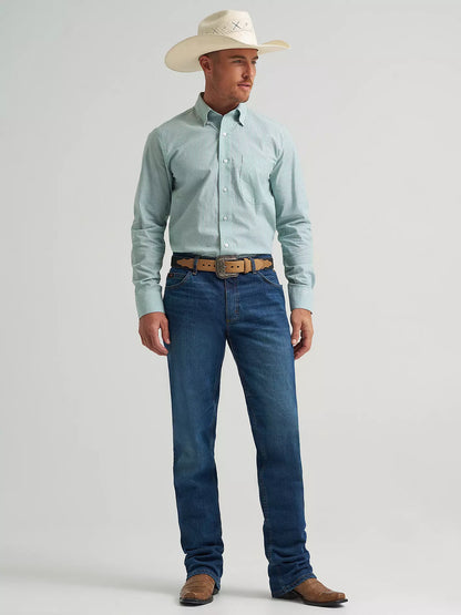 Man wearing a light blue button-up shirt, dark blue jeans, and a white cowboy hat on a gray background