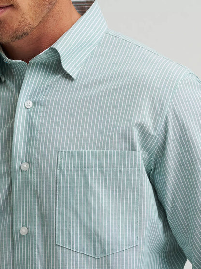 Close-up of a man wearing a light green striped shirt with a collar.
