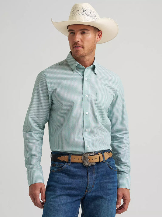 Man wearing a light blue checkered shirt, white cowboy hat, and blue jeans on a gray background