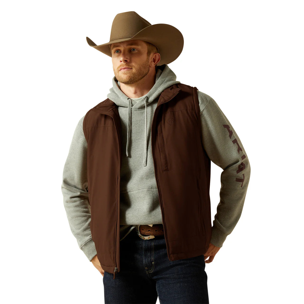 Man in a cowboy hat, brown vest, and grey hoodie with Western casual outfit