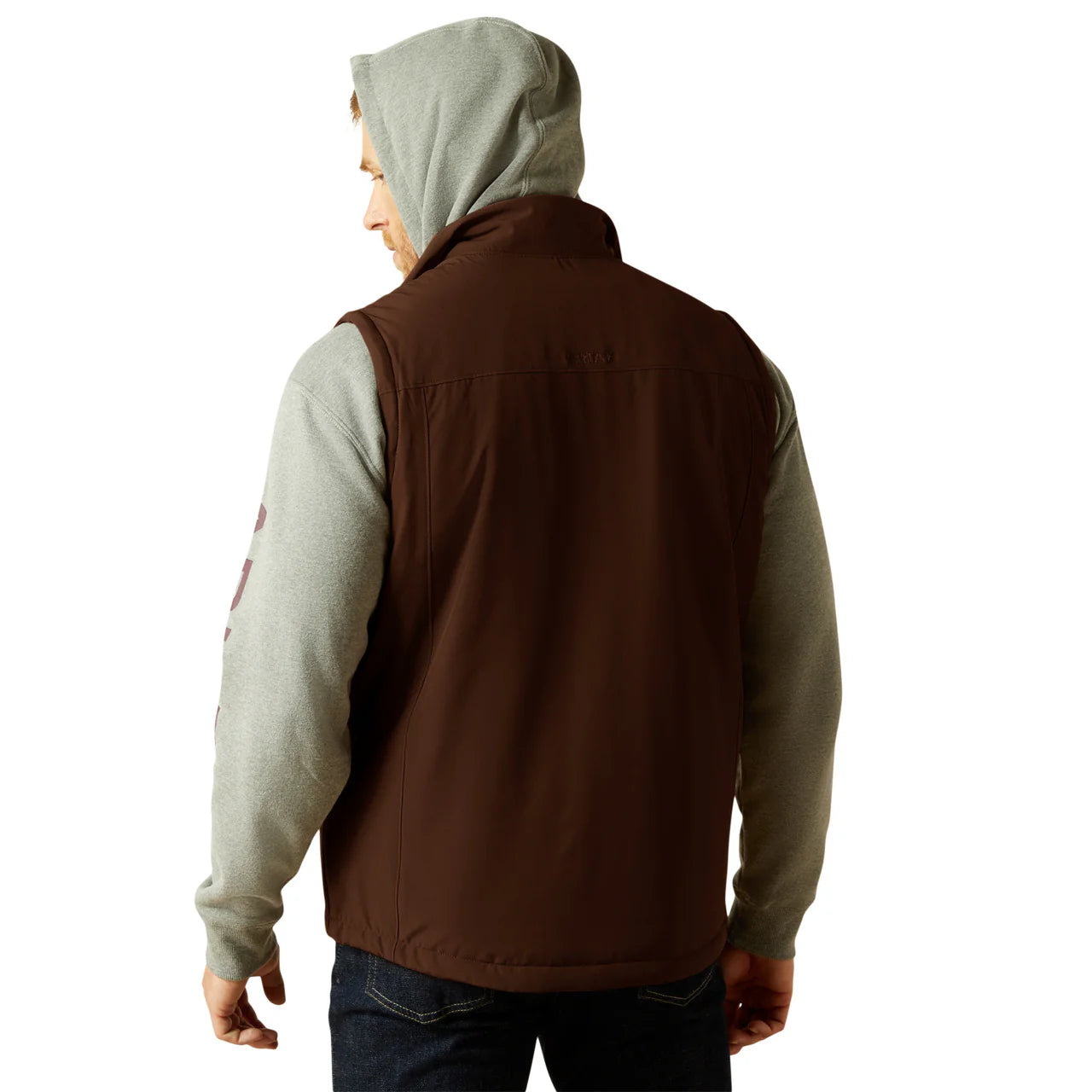 Man wearing brown outdoor vest over gray hoodie, back view, casual outfit