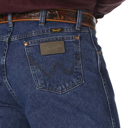 Close-up of blue jeans with a brand logo on the pocket against a white background