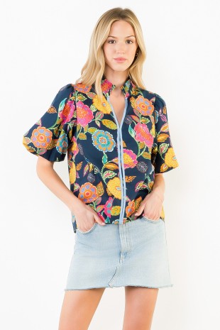Woman wearing a colorful floral jacket on a white background