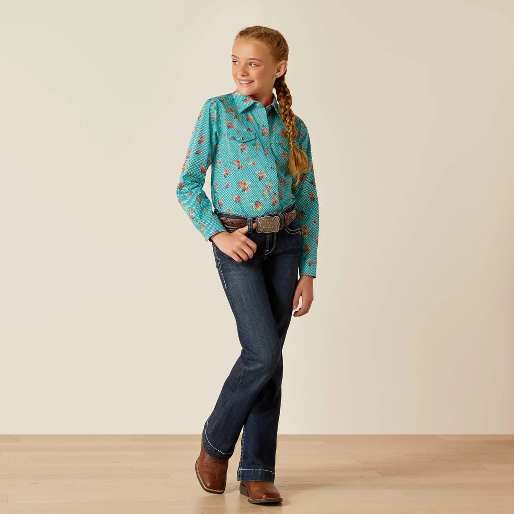 Girl wearing turquoise floral western shirt, dark blue jeans, and brown cowboy boots