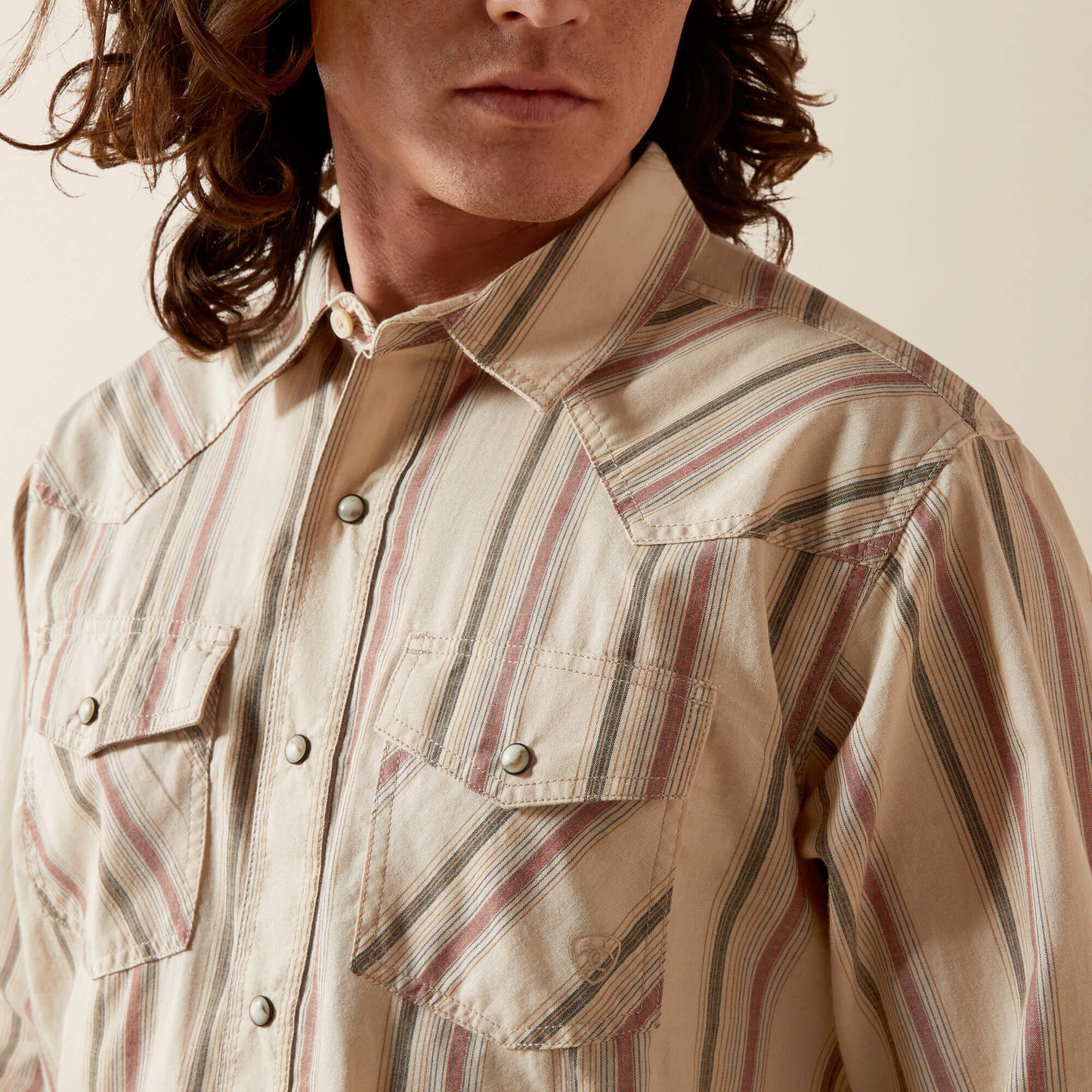 Men's beige striped western shirt with snap buttons and chest pockets, close-up view