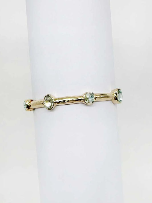 Gold bracelet with  gemstones on a white background