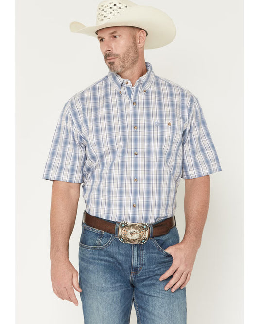 Man wearing a blue plaid shirt, jeans, and a cowboy hat on a white background