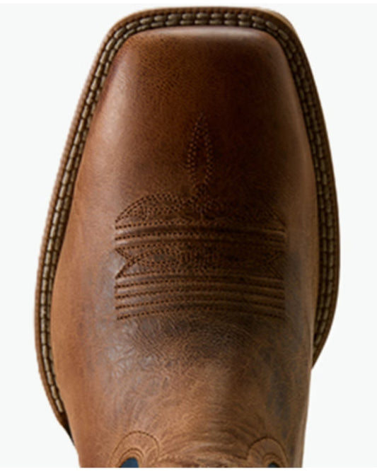 A close-up top-down view of a brown leather cowboy boot toe, showing the square toe shape, decorative stitching, and textured leather on a white background.