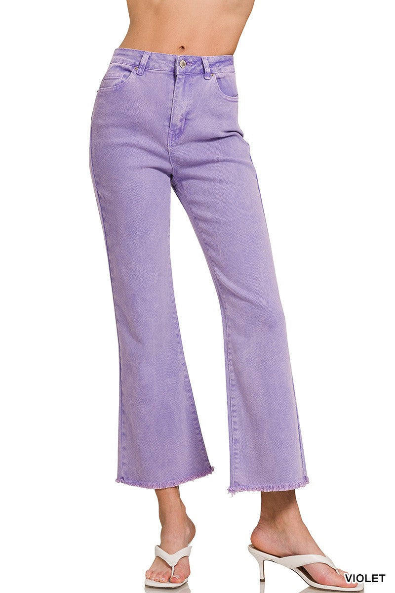 Purple jeans worn by a person on a white background