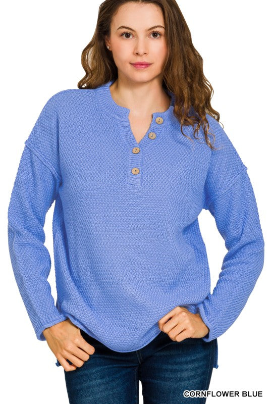 Woman wearing cornflower blue textured knit pullover with button neck and long sleeves