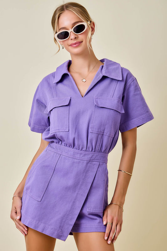 Woman wearing a purple dress with a neutral background