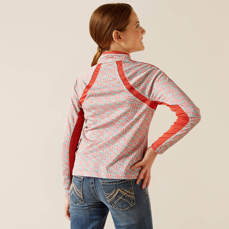 Girl wearing floral print jacket with red accents and embroidered blue jeans, back view