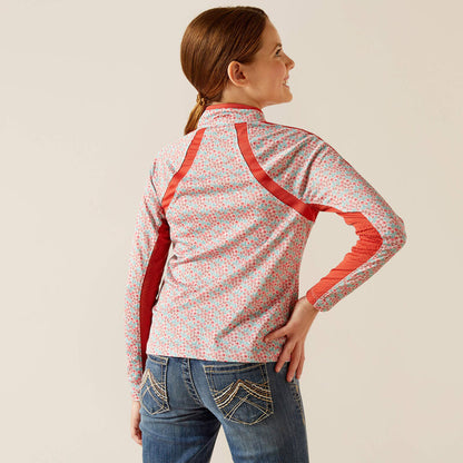 Girl wearing floral print jacket with red accents and embroidered blue jeans, back view