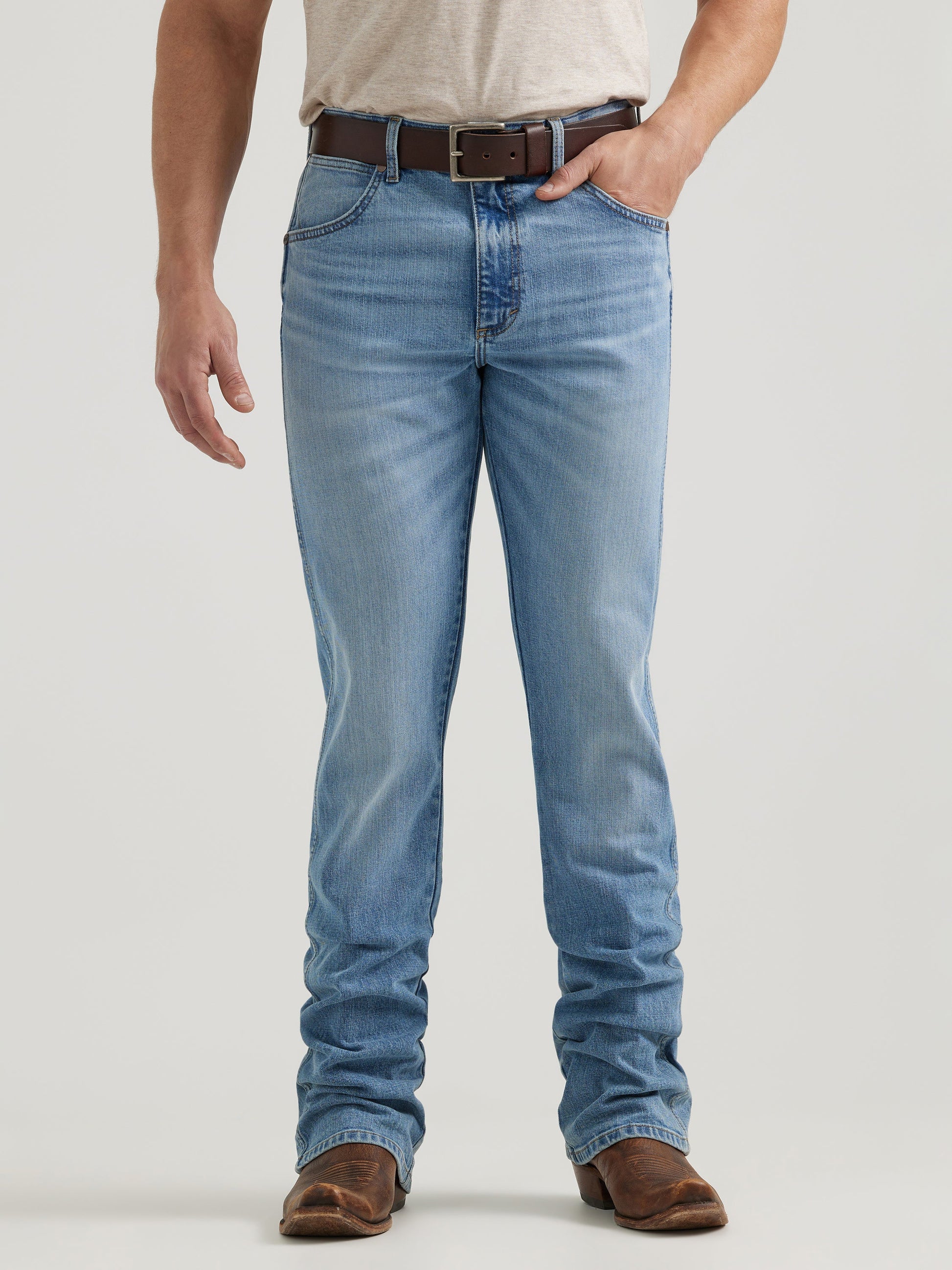 Men's light wash straight leg jeans with brown belt and leather boots