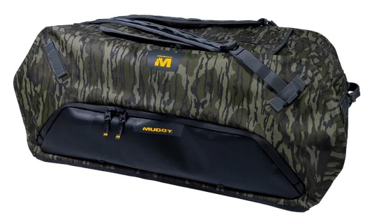 A Muddy brand duffel bag featuring a green and brown camouflage pattern with a solid black lower front pocket and black straps, shown on a plain white background.