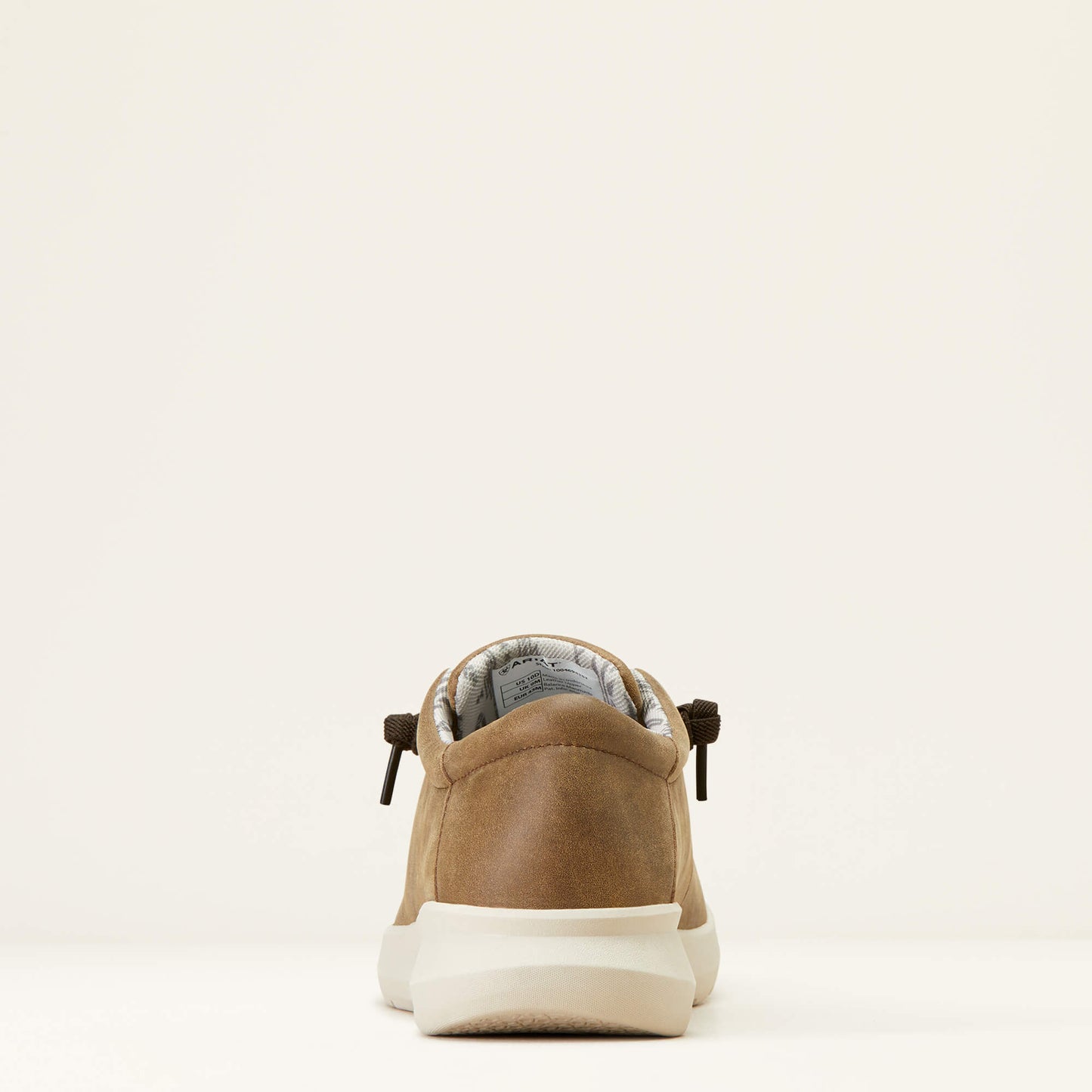 Rear view of tan suede casual shoe with white sole on a plain background