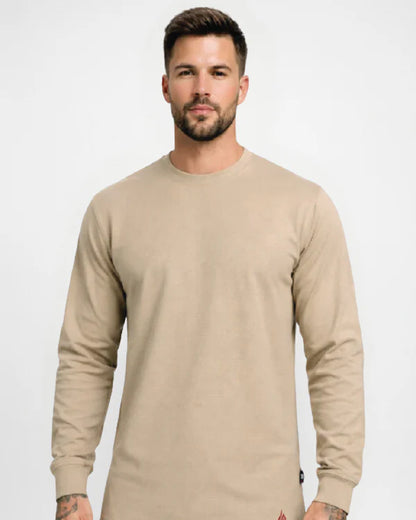 Man wearing a beige long-sleeve shirt against a white background