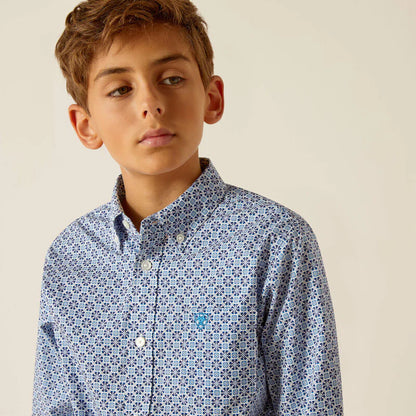 Boy wearing blue patterned button-down shirt with small geometric design