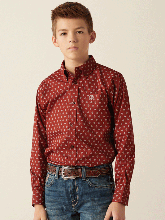 Boy in red patterned long sleeve western shirt and jeans with brown leather belt