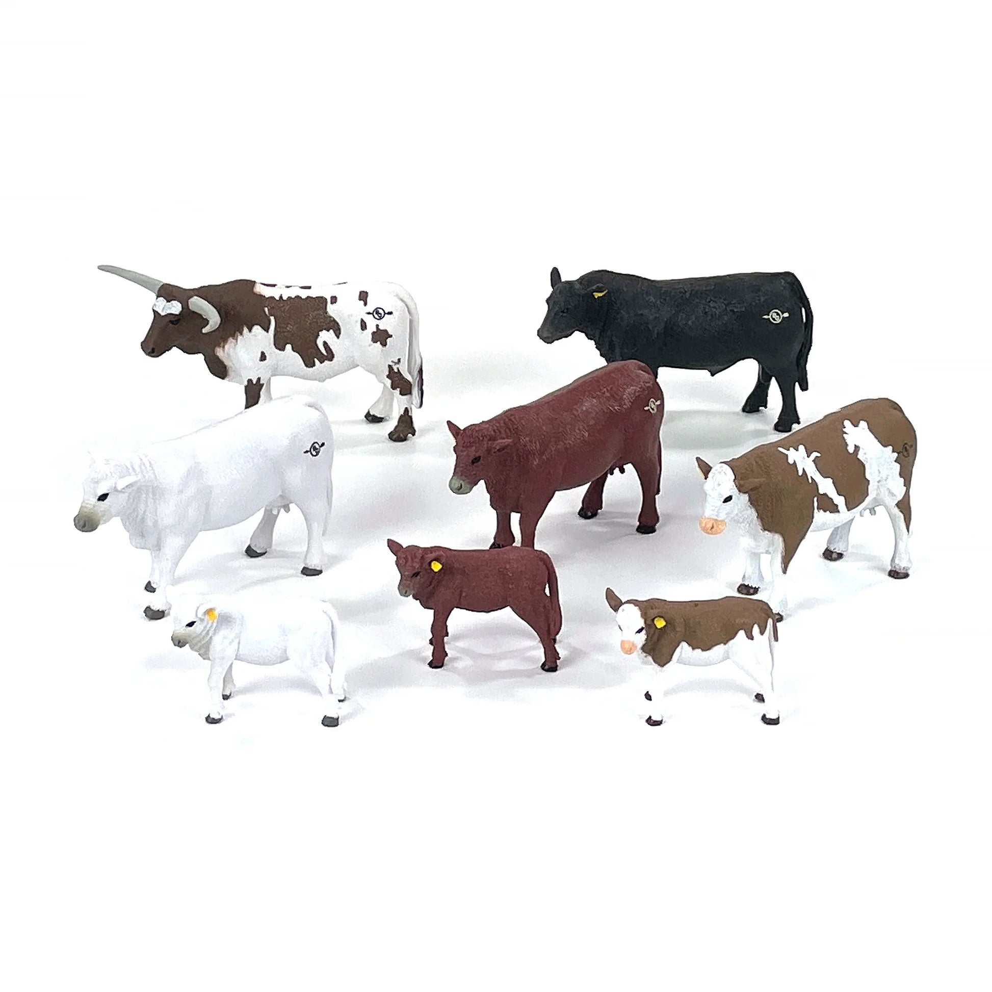 Assorted plastic farm animal figurines, including cows and calves, on white background