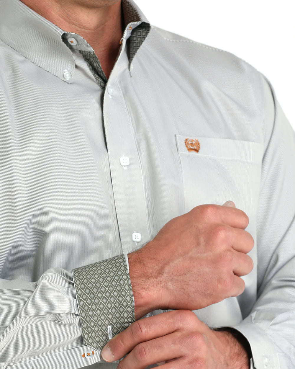 Man wearing light gray button-down shirt with patterned cuffs and chest pocket