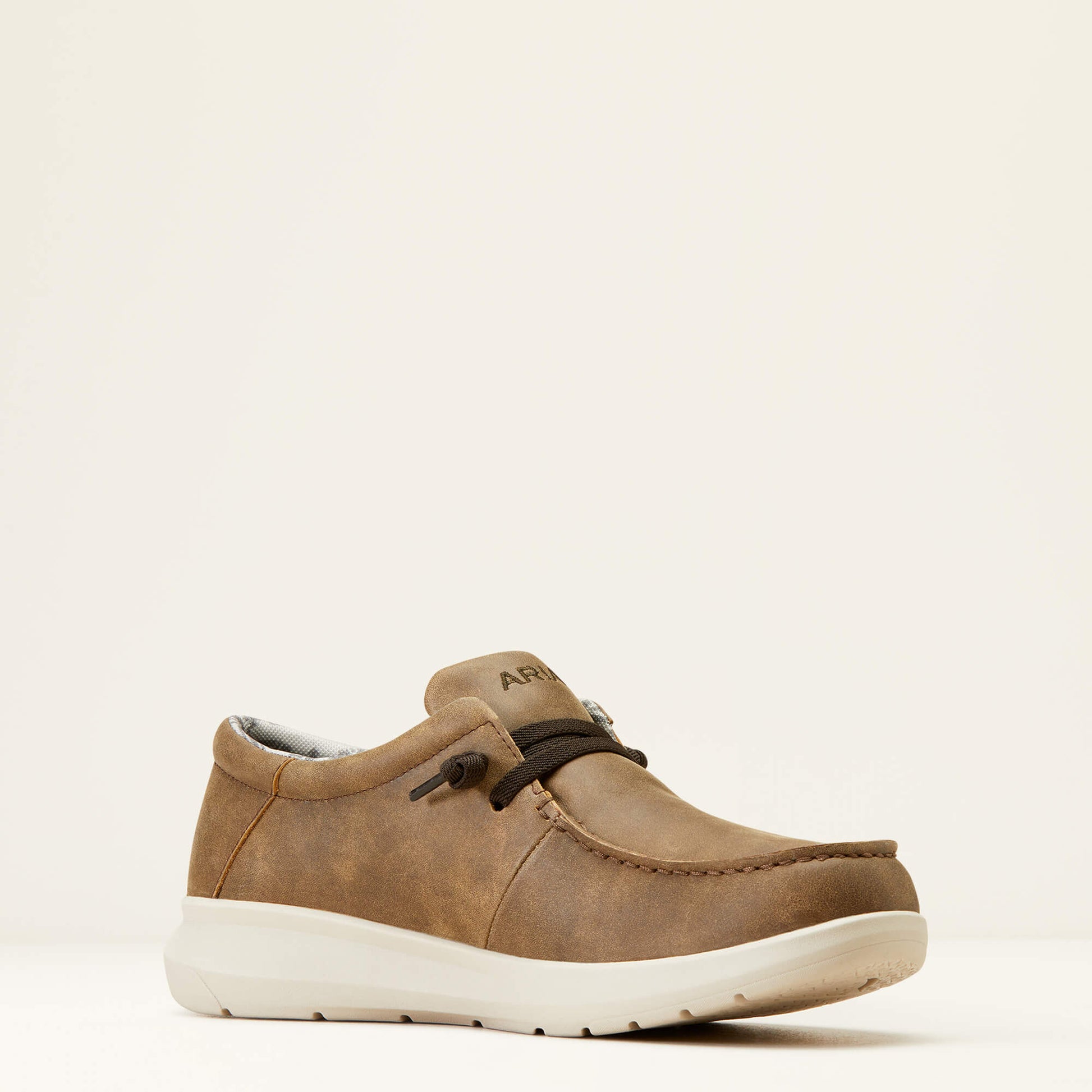 Brown leather casual loafer shoe with white sole on neutral background