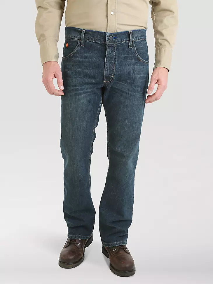Men's straight leg blue jeans with work boots and beige shirt, front view