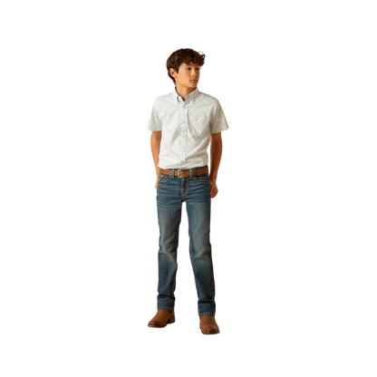 Boy wearing a short sleeve button-up shirt, blue jeans, and brown boots
