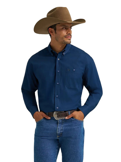 Man in cowboy hat, blue western shirt, and jeans with belt buckle on white background