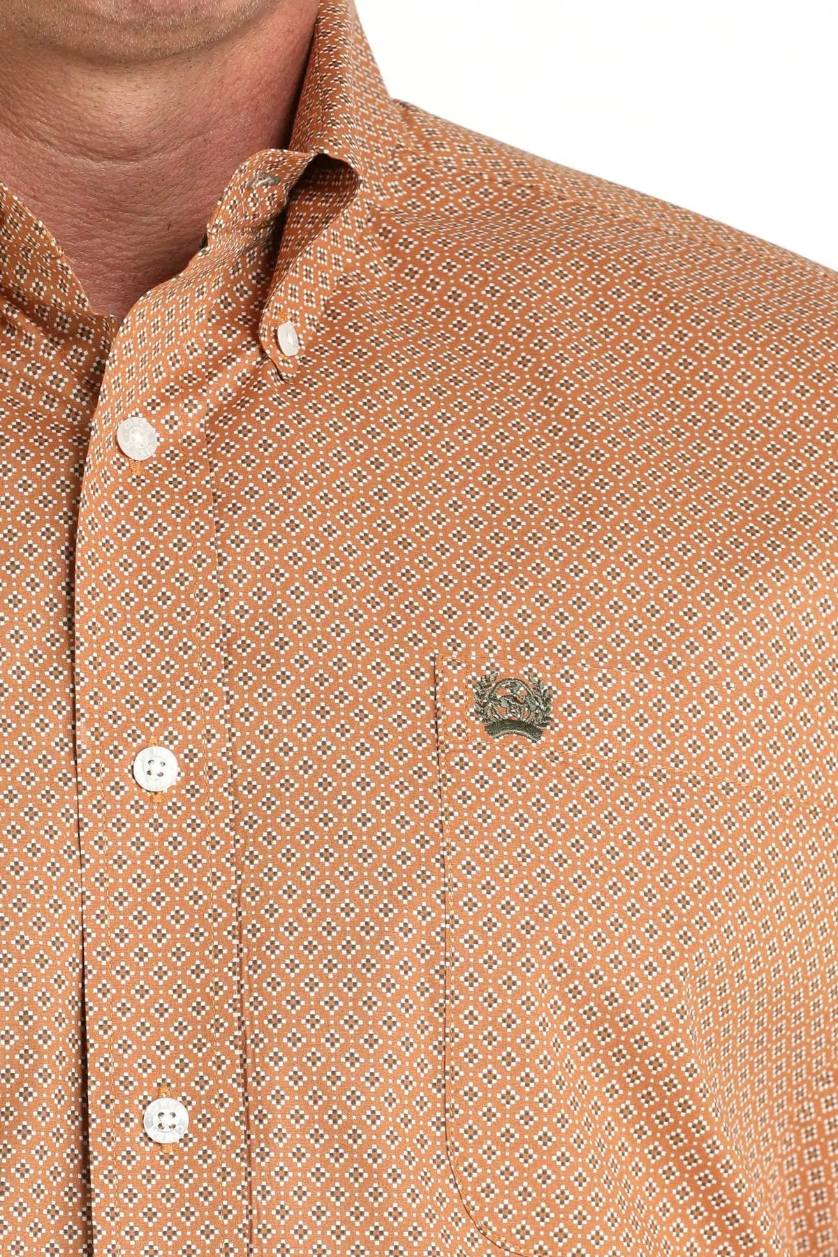 Men's orange geometric patterned button-down shirt with chest pocket and metal badge